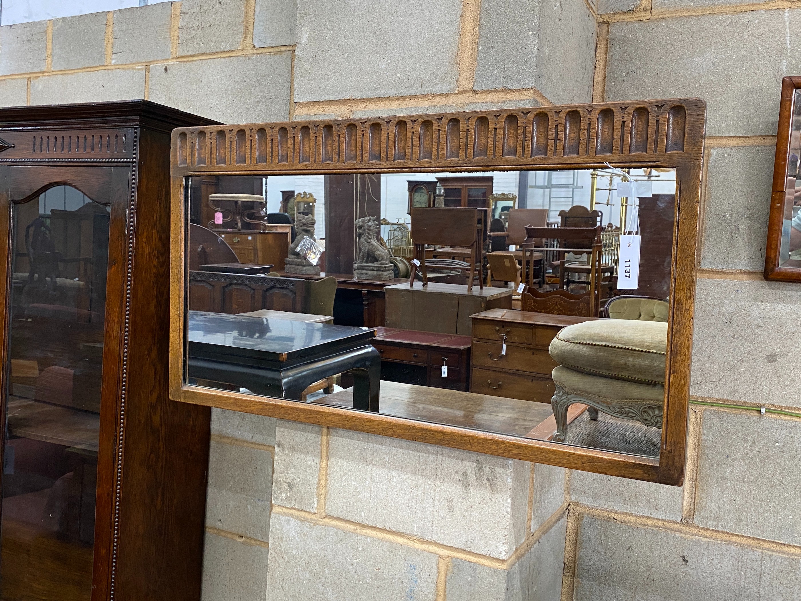A 1920's rectangular oak wall mirror, width 90cm, height 50cm